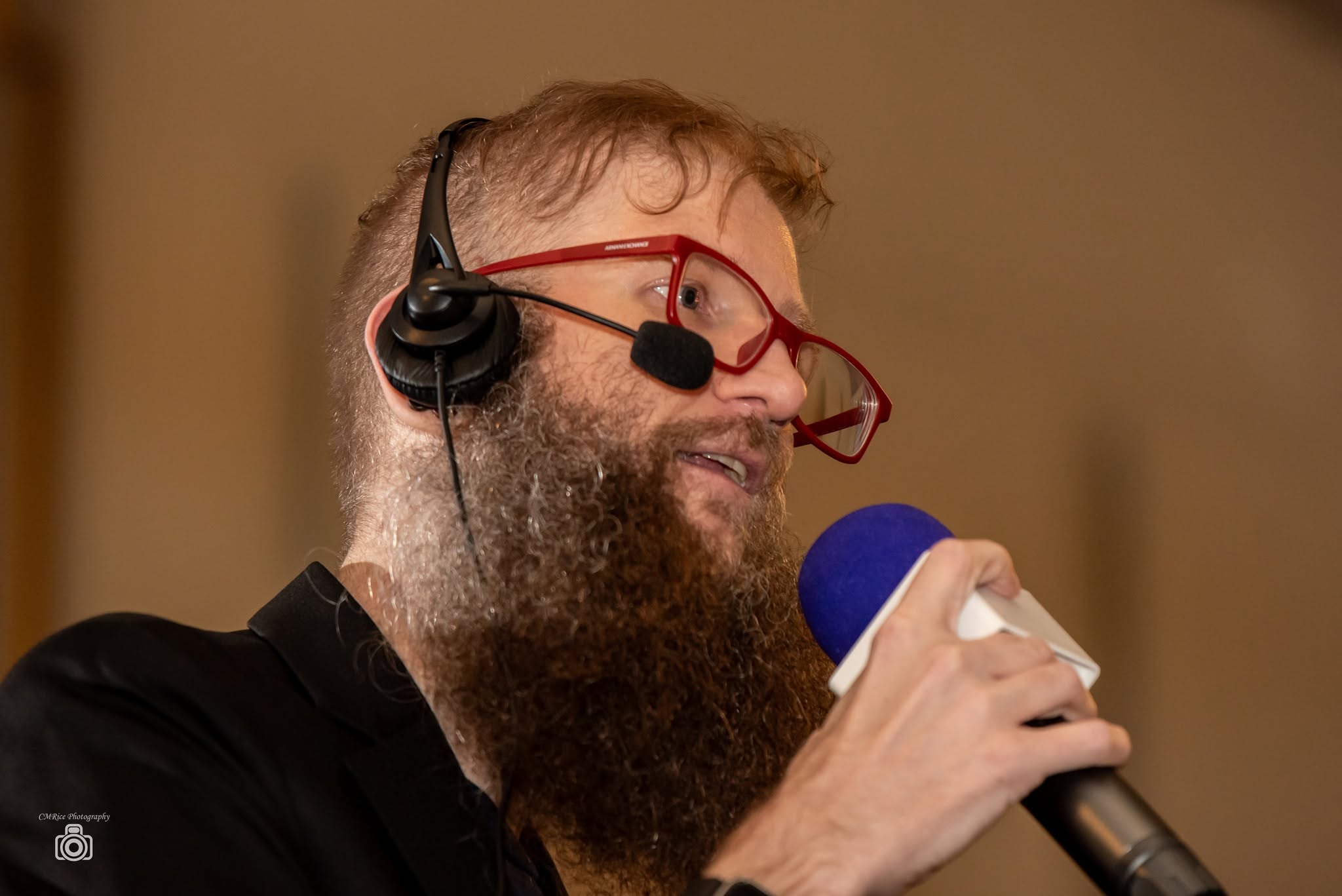 Adam Starling speaking into a microphone at Vendetta at the Opera House